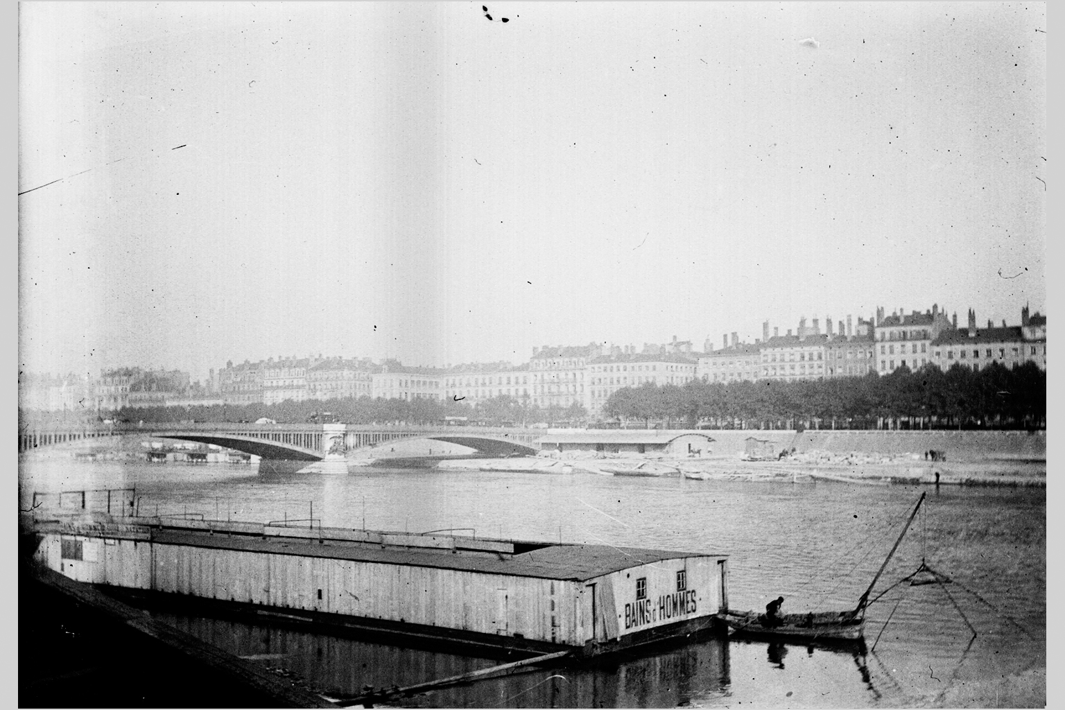 Quai Sarrail (?) et pont de l'Hôtel-Dieu, à Lyon : bains d'hommes sur le fleuve ; pêcheur : photo négative NB sur plaque de verre (vers 1900, cote : 10PH/193)